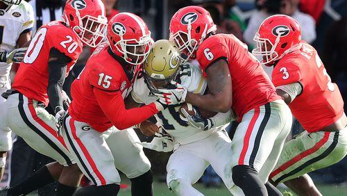 Georgia linebacker Natrez Patrick (6), showing here with defenders J.R. Reed (from left), D’Andre Walker and Roquan Smith, swarm Georgia Tech quarterback TaQuon Marshall during the second half of a game last month.