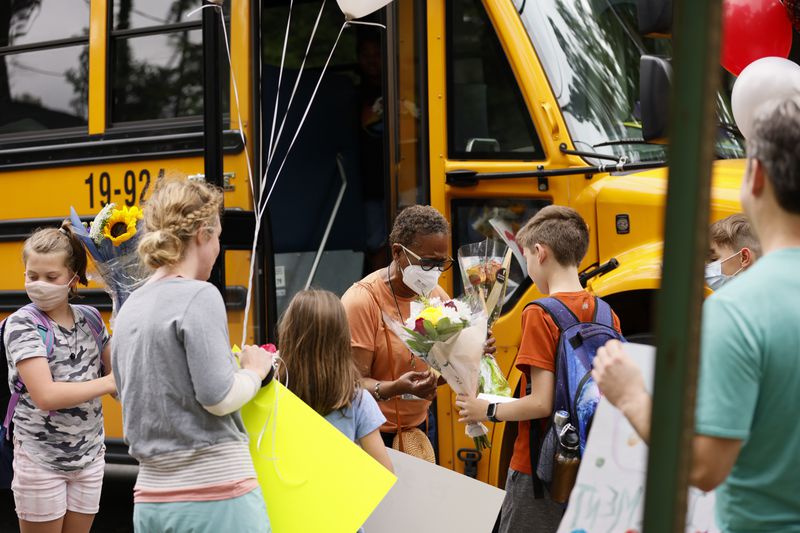Atlanta Public Schools bus driver Alma Jennings received flowers and balloons from parents and students along her bus route on Monday, May 23, 2022. (Natrice Miller / natrice.miller@ajc.com)