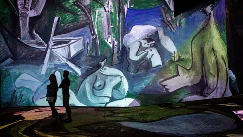People look over the Imagine Picasso Atlanta: Immersive Art Exhibition on opening day at Pullman Yards in Atlanta Thursday, 17 2022.   STEVE SCHAEFER FOR THE ATLANTA JOURNAL-CONSTITUTION