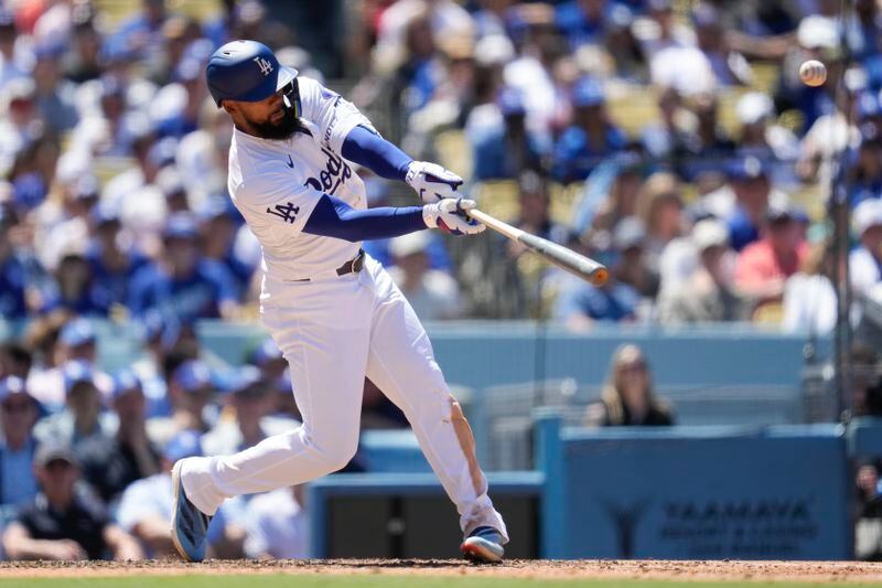 Los Angeles Dodgers' Teoscar Hernández hits a home run during the sixth inning of a baseball game against the Atlanta Braves in Los Angeles, Sunday, May 5, 2024. (AP Photo/Ashley Landis)