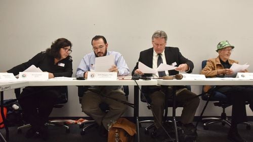 Gwinnett elections board members Alice O’Lenick (far left) and Ben Satterfield (far right), shown here in a 2018 file photo, are refuting allegations of racism based on their social media activity. HYOSUB SHIN / HSHIN@AJC.COM