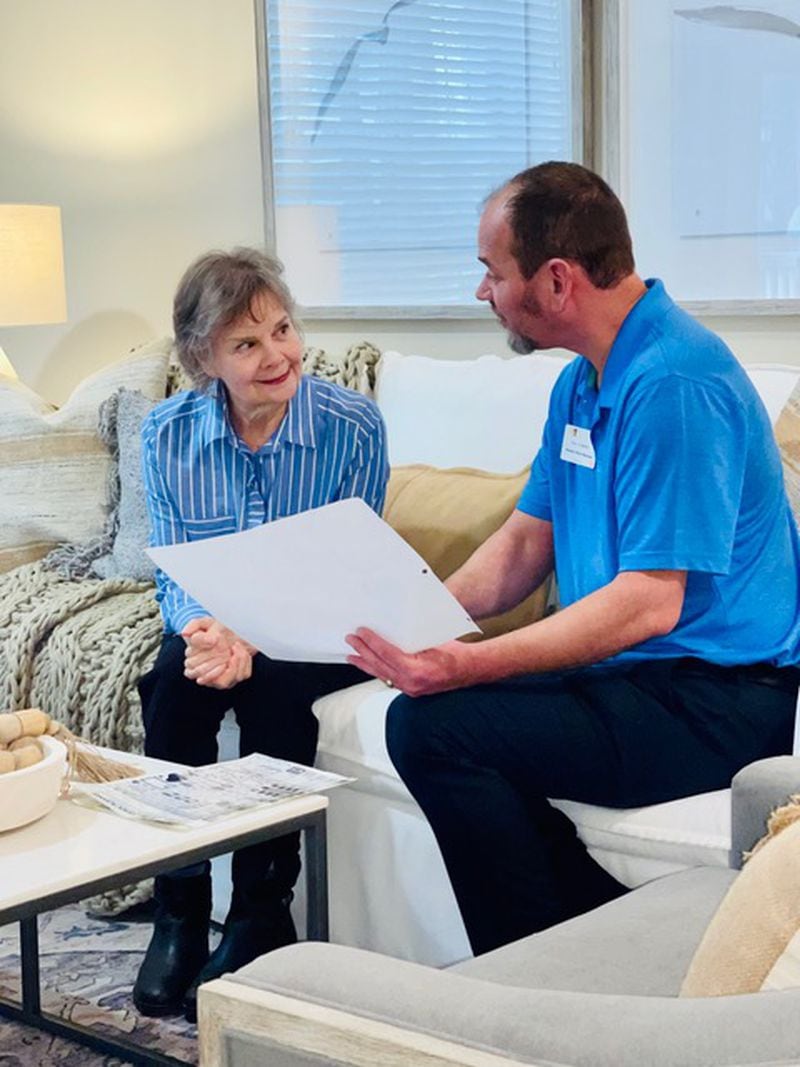 Joey Adams, right, is member move manager at Park Springs, a senior living community in Stone Mountain. Here, he consults with Park Springs member Martha Lott on furniture layout.