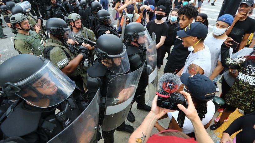 053120 Atlanta: Riot police and protesters face off outside the CNN Center at Olympic Park during the third day of protests over the death of George Floyd on Sunday, May 31, 2020, in Atlanta.     Curtis Compton ccompton@ajc.com