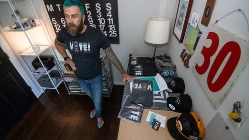 Buzz Busbee, owner of the T-shirt and clothing design brand AbetterBuzz, works in his home office in Atlanta on Oct. 3, 2020.   STEVE SCHAEFER / SPECIAL TO THE AJC