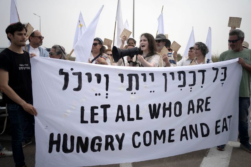 American and Israeli rabbis from Rabbis for Ceasefire hold matzoh for the Jewish holiday of Passover after they marched towards the Erez crossing to the Gaza Strip with food aid for Gaza civilians and to call for a ceasefire, in southern Israel, Friday, April 26, 2024. (AP Photo/Maya Alleruzzo)