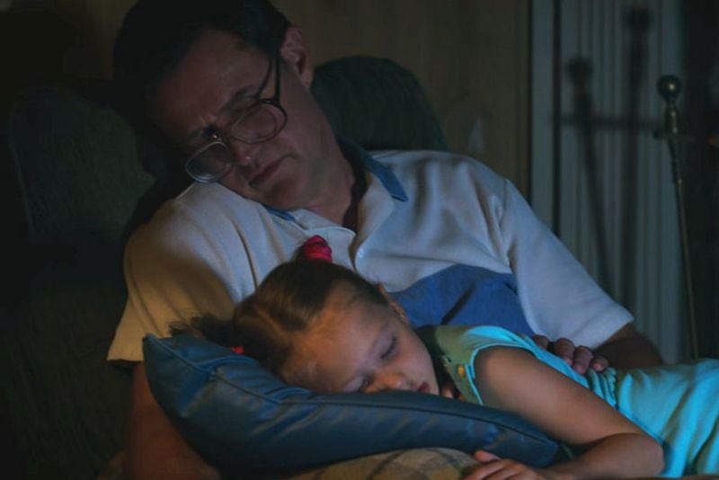 Joe Chrest plays Mike's dad Ted, who is napping with his daughter Holly (played by twins Tinsley & Anniston Price )