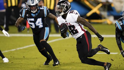 Atlanta Falcons wide receiver Calvin Ridley runs past Carolina Panthers outside linebacker Shaq Thompson during the first half of an NFL football game Thursday, Oct. 29, 2020, in Charlotte, N.C. (AP Photo/Gerry Broome)