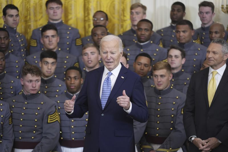 President Joe Biden speaks during an event to present the Commander-in-Chief's Trophy to the United States Military Academy Army Black Knights, in the East Room of the White House, Monday, May 6, 2024, in Washington, as head coach Jeff Monken, right, looks on. (AP Photo/Evan Vucci)