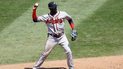 Braves second baseman Adeiny Hechavarria throws to first base after fielding a ground out by Philadelphia Phillies' Jean Segura during the second inning of the first baseball game in a doubleheader, Sunday, Aug. 9, 2020, in Philadelphia. (AP Photo/Matt Slocum)