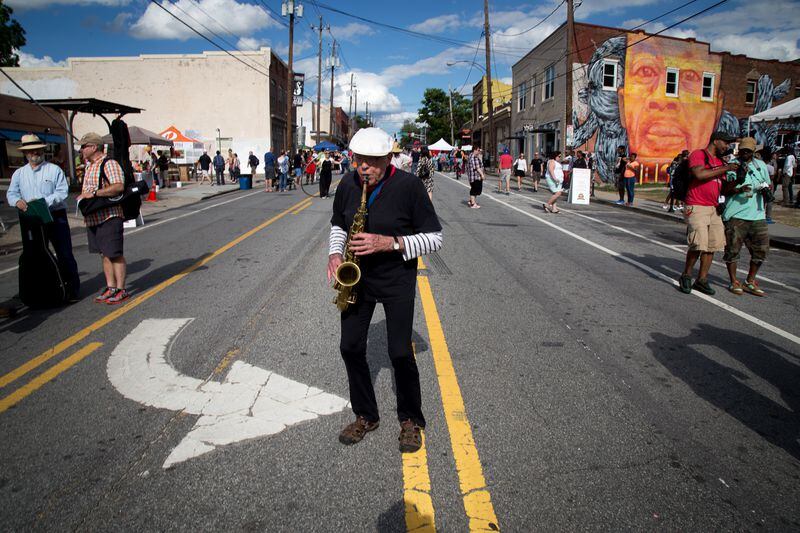Steve Seaberg plays his saxaphone as he wonders down Edgewood Avenue during the Fire in the Fourth Festival, in Atlanta on Saturday May 21, 2016. STEVE SCHAEFER / SPECIAL TO THE AJC