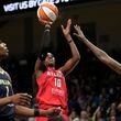 Dream guard Rhyne Howard (10) takes a shot as Dallas Wings' Teaira McCowan, left, and Natasha Howard (6) defend in the first half of Game 2 of a first-round WNBA basketball playoff series, Tuesday, Sept. 19, 2023, in Arlington, Texas. (AP Photo/Tony Gutierrez)