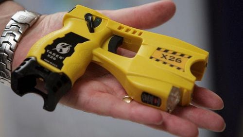 A representative from Taser International shows the companies latest X26 stun gun during the Police Federation Conference at Winter Gardens on May 16, 2007, in Blackpool, England. (Photo by Christopher Furlong/Getty Images)