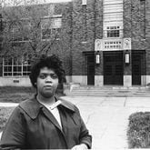 FILE - This May 8, 1964 file photo shows Linda Brown Smith standing in front of the Sumner School in Topeka, Kansas. The refusal of the public school to admit Brown in 1951, when she was 9 years old, led to the Brown v. Board of Education of Topeka, Kansas lawsuit. In 1954, the U.S. Supreme Court mandated that schools nationwide must be desegregated.  (AP Photo, File)