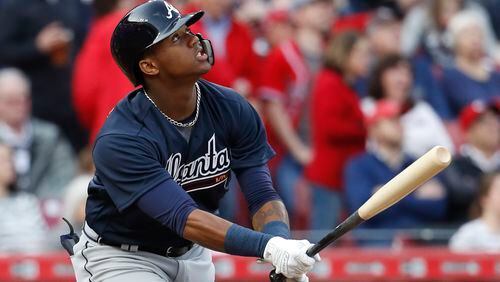 Atlanta Braves' Ronald Acuna Jr. flies out against Cincinnati Reds starting pitcher Brandon Finnegan during the first inning of a baseball game, his first at-bat in the majors, Wednesday, April 25, 2018, in Cincinnati. (AP Photo/John Minchillo)