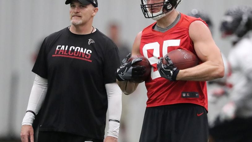 Atlanta Falcons tight end Eric Saubert and head coach Dan Quinn watch a play during organized team activities on Tuesday, May 22, 2018, in Flowery Branch.   Curtis Compton/ccompton@ajc.com