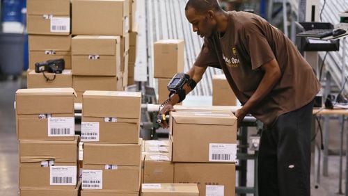 September 19, 2014 - Suwanee - Using a wrist mounted bar code reader, Kyle Kelly readies a shipment from the healthcare distribution center in Suwanee. UPS does logistics for healthcare companies at its facility in Suwanee, and other companies including Pratt & Whitney at its distribution center near Hartsfield Jackson Airport. Logistics is the engine humming behind much of Atlantaâ€™s economic activity connected to the rest of the world. Itâ€™s the backbone for a globalized economy, and Sandy Springs-based UPS, Atlanta-based Manhattan Associates and other local companies play leading roles in the industry. BOB ANDRES / BANDRES@AJC.COM