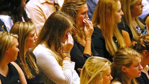 Friends and loved ones weep during a service for Emily Elizabeth Clark in April 2015. Clark and four other nursing students from Georgia Southern University were killed in a multi-vehicle accident on I-16. Curtis Compton / ccompton@ajc.com