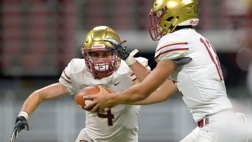 Brookwood QB Dylan Lonergan (12) hands the ball off to RB Eli Kohl (4) in the second half of their game at the Mercedes Benz Stadium in Atlanta during the Corky Kell Classic Saturday, August 24, 2019. PHOTO/Daniel Varnado