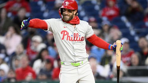 Philadelphia Phillies Bryce Harper gestures during his at-bat in the third inning of a baseball game against the Washington Nationals, Friday, April 5, 2024, in Washington. (AP Photo/Nick Wass)