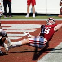 Oklahoma running back Austin Stogner (18) tries to make a one-handed catch in the end zone during the second overtime as Texas defensive back Chris Brown (15) looks on at the Cotton Bowl in Dallas on Saturday, Oct. 10, 2020. Oklahoma won in quadruple overtime, 53-45. (Tom Fox/Dallas Morning News/TNS)