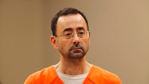 FILE - In this Nov. 22, 2017, file photo, Dr. Larry Nassar, appears in court for a plea hearing in Lansing, Mich. Nassar, an elite Michigan sports doctor who possessed child pornography and assaulted gymnasts, was sentenced Thursday, Dec. 7, 2017,  to 60 years in federal prison in one of three criminal cases that ensure he will never be free again. (AP Photo/Paul Sancya, File)