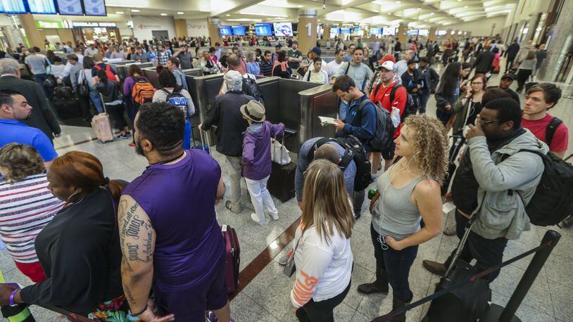 Long lines for airport security screening stretched through the domestic terminal and snaked through baggage claim at Hartsfield-Jackson International on Monday, May, 9, 2016. The airport is now advising travelers to get to the terminal three hours before their flight. JOHN SPINK / JSPINK@AJC.COM