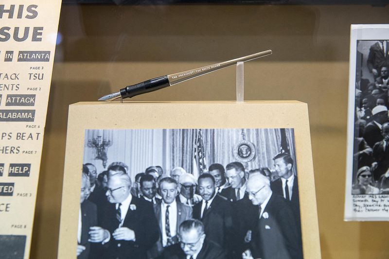 Five months after Bloody Sunday, John Lewis and Martin Luther King Jr. were guests of President Lyndon B. Johnson as he signed the 1965 Voting Rights Act into law. After the signing, Johnson gave Lewis a commemorative pen, which is now on display in a permanent art exhibit at Atlanta's Hartsfield Jackson International Airport. (Alyssa Pointer / alyssa.pointer@ajc.com)