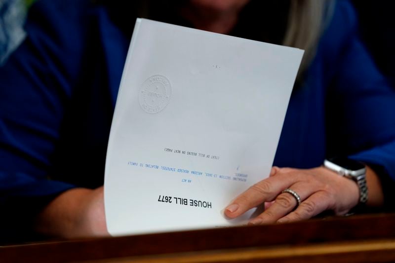 Arizona Gov. Katie Hobbs signs the repeal of the Civil War-era near-total abortion ban, Thursday, May 2, 2024, at the Capitol in Phoenix. Democrats secured enough votes in the Arizona Senate to repeal the ban on abortions that the state's highest court recently allowed to take effect. (AP Photo/Matt York)