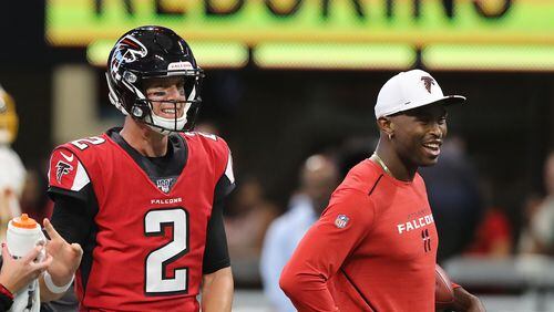 Falcons quarterback Matt Ryan and wide reciever Julio Jones, who is being held out of the game, share a laugh before the game.  Curtis Compton/ccompton@ajc.com