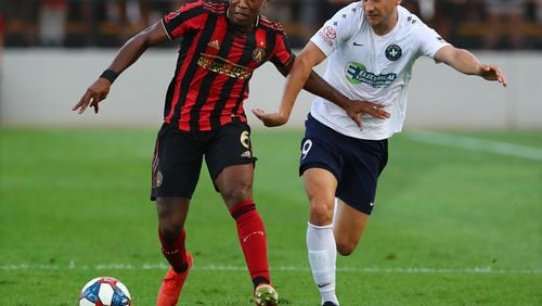 Atlanta United midfielder Darlington Nagbe works against St. Louis forward Russell Cicerone in a U.S. Open Cup quarterfinals soccer match on Wednesday, July 10, 2019, in Kennesaw.  Curtis Compton/ccompton@ajc.com