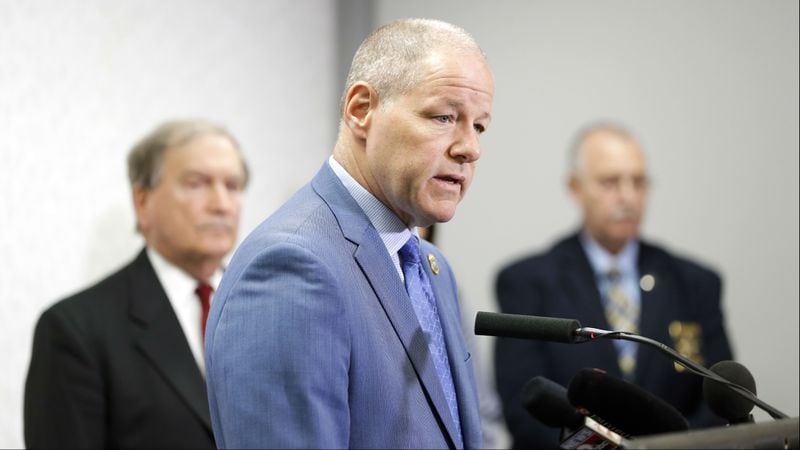 Tennessee Bureau of Investigation Director David Rausch, center, speaks at a news conference at the Tennessee Bureau of Investigation Monday, April 29, 2019, in Nashville, regarding the case of Michael Lee Cummins. Cummins, 25, of Westmoreland, Tennessee, is accused of killing six people found beaten to death in their home Saturday, April 27, 2019, including his parents, uncle and a 12-year-old girl. Cummins is also charged in the death of a seventh person found beaten to death in her home that same day, as well as that of a man whose headless body was found near his cabin just outside Westmoreland April 17, 2019.