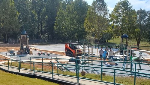 Construction workers in Dacula putting the finishing touches on the the Maple Creek Park playground. (Courtesy City of Dacula)