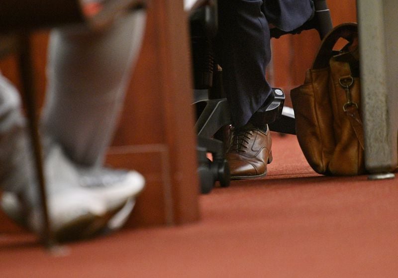 Attorney William McCall Calhoun wears a GPS ankle monitoring device even as he represents his clients in court. Calhoun is out on bond and faces five federal charges related to the breaching of the Capitol. The most serious is obstructing an official proceeding, a felony that carries a prison sentence of up to 20 years. (Hyosub Shin / Hyosub.Shin@ajc.com)