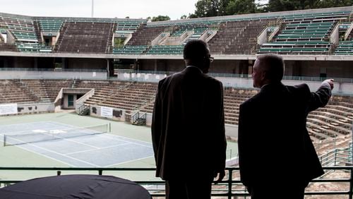 Gwinnett County Administrator Glenn Stephens, right, and Gwinnett Corrections Warden Darrell Johnson speak Tuesday before a press conference and "ceremonial demolition" at the Stone Mountain Tennis Center. Chad Rhym / Chad.Rhym@ajc.com