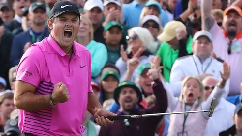 Patrick Reed lets the world know he's a Masters champion, canning his par putt on No. 18 Sunday. (Curtis Compton/ccompton@ajc.com)