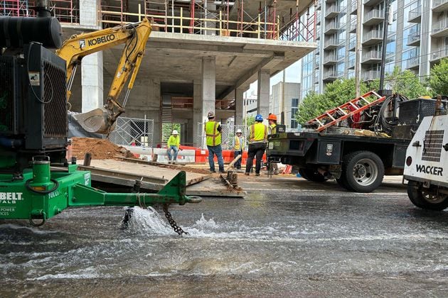 Crews work to repair the water main break at West Peachtree in Midtown Atlanta on Sunday, June 2, 2024. Multiple water main breaks left much of the city without water over the weekend. (David Aaro/AJC)