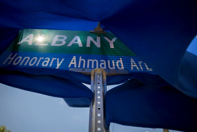 BRUNSWICK, GA - AUGUST, 9, 2022: A slight breeze blows the blue cover over a street sign before the City of Brunswick commemorates Albany Street in downtown Brunswick in honor of Ahmaud Arbery. (AJC Photo/Stephen B. Morton)