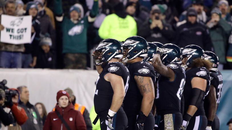 Philadelphia Eagles players salute as they celebrate a touchdown pass from quarterback Carson Wentz to tight end Zach Ertz late in the third quarter against the Dallas Cowboys.
