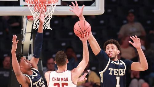 Georgia Tech defenders Khalid Moore (left) and James Banks III block a shot by Boston College guard Jordan Chatman in a NCAA college basketball game on Sunday, March 3, 2019, in Atlanta.    Curtis Compton/ccompton@ajc.com