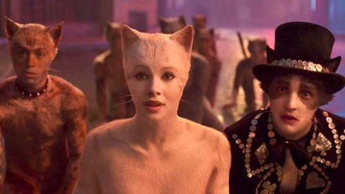 Francesca Hayward portrays Victoria, center, and Laurie Davidson as Mr. Mistoffelees, right, in “Cats.” Universal Pictures
