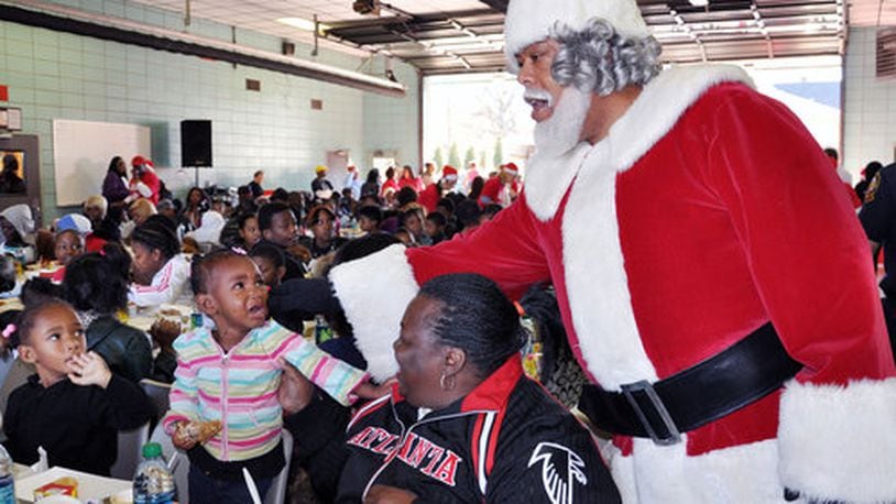 In this file photo, Santa checks in and greets kids and their families at the Firehouse Toy Drive & Luncheon.