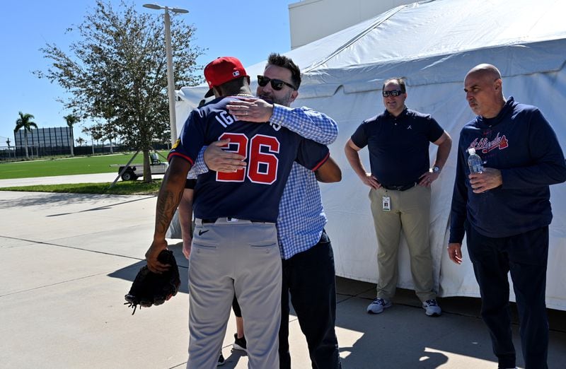 Atlanta Braves relief pitcher Raisel Iglesias is greeted by general manager Alex Anthopoulos after throwing in the bullpen during the first full-squad spring training workout at CoolToday Park, Tuesday, February, 20, 2024, in North Port, Florida. (Hyosub Shin / Hyosub.Shin@ajc.com)