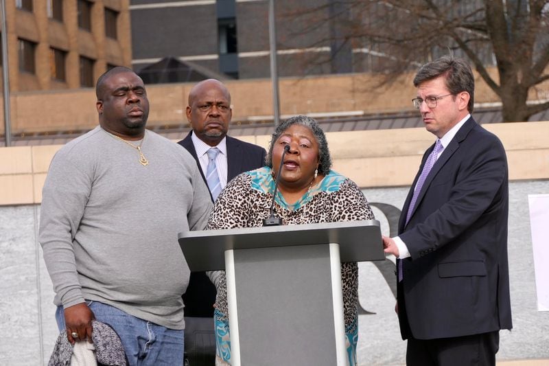 Julian Lewis' widow, Betty Lewis, speaks about the death of her husband, who was shot and killed by a Georgia State Patrol trooper near his Sylvania home in August 2020. She was flanked by her son Eric Clay (left) and the family's attorneys, Andrew Lampros (right) and Akil Secret, during a news conference at the Georgia State Capitol.