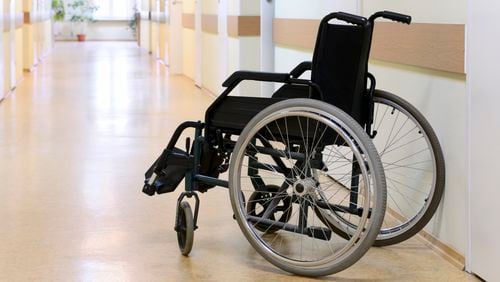 Wheel chair in the hospital corridor. Wheel chair stands in the corridor of the hospital door.