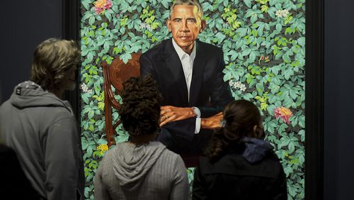 Visitors to Atlanta's High Museum of Art examine artist Kehinde Wiley’s painting of former President Barack Obama in January 2022. (Daniel Varnado/AJC FILE PHOTO)