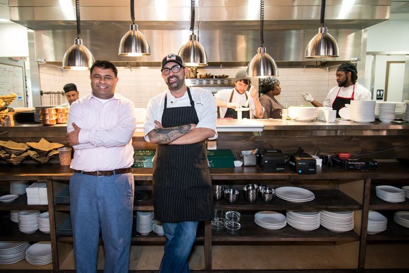 Owner Sandeep Kothary and chef Bhavesh Patel (from left to right) in front of Amara's open kitchen. Photo credit: Mia Yakel.