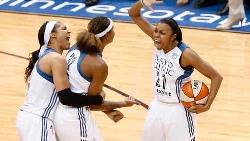 FINALS CELEBRATION--Minnesota Lynx forward Maya Moore from left, forward Rebekkah Brunson and Renee Montgomery (21) celebrate against the Indiana Fever in the second half of Game 5 of the WNBA basketball finals, Wednesday, Oct. 14, 2015, in Minneapolis. (AP Photo/Stacy Bengs)