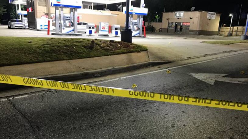 Investigators said a gunman began firing into a crowd of people outside a Chevron station, which is near a smoke shop.