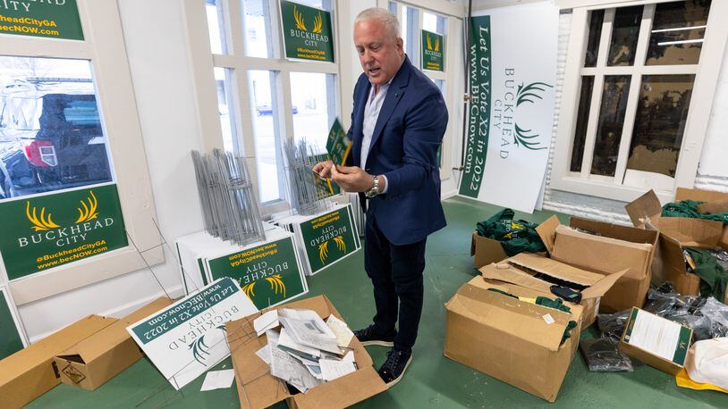 Bill White, chairman and chief executive officer of the Buckhead City Committee, looks through some of the boxes that are left to move from the organization's headquarters on Thursday, Mar. 30, 2023.  (Steve Schaefer/steve.schaefer@ajc.com)