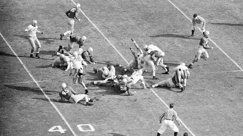 His head down, Georgia's Frankie Sinkwich drills through the UCLA line for a five-yard gain in the Rose Bowl Jan. 1, 1943, at Pasadena, Calif.